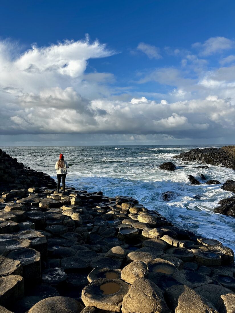 A woman on a rocky shore