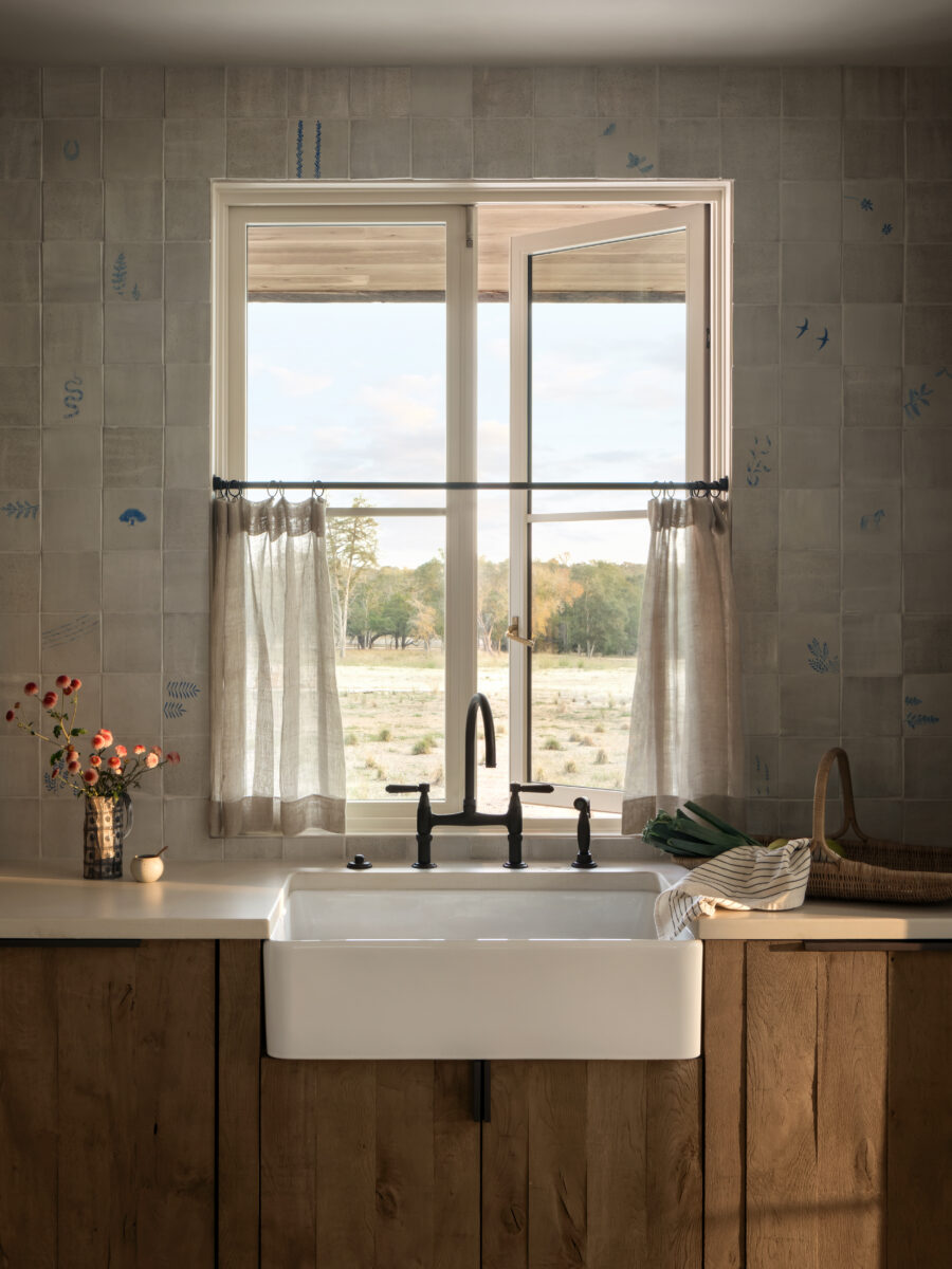 image of kitchen window with painted tile backsplash