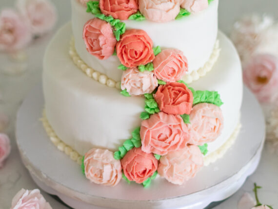 A spring cake decorated with flowers and buttercream icing