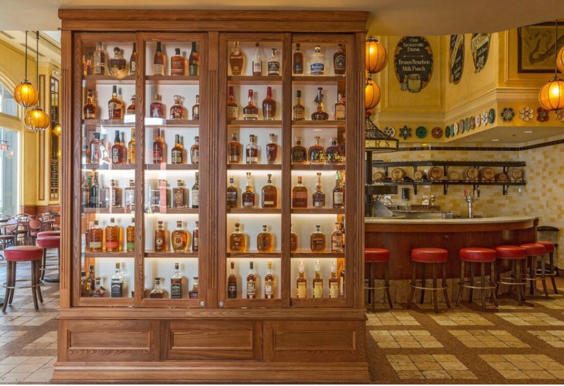 image of a wall of shelves with bourbon