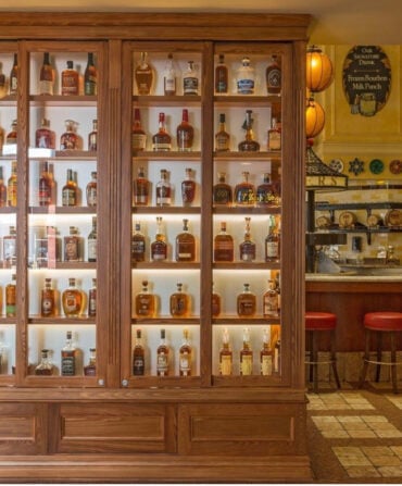 image of a wall of shelves with bourbon