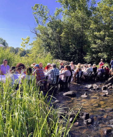 A dining table with people in a river