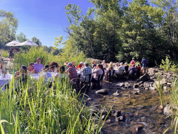 A dining table with people in a river