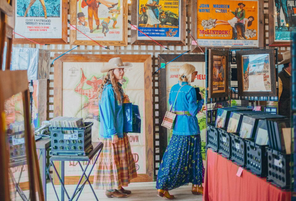 Women walk through an antique store