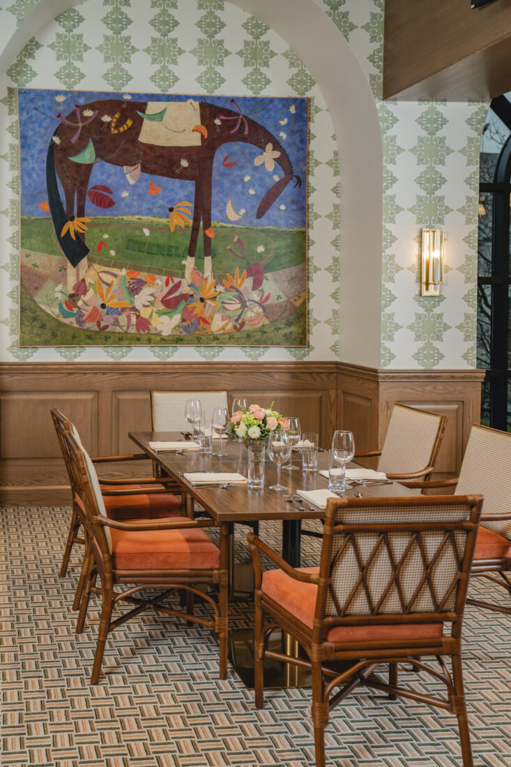 A dining room with a painting of a horse