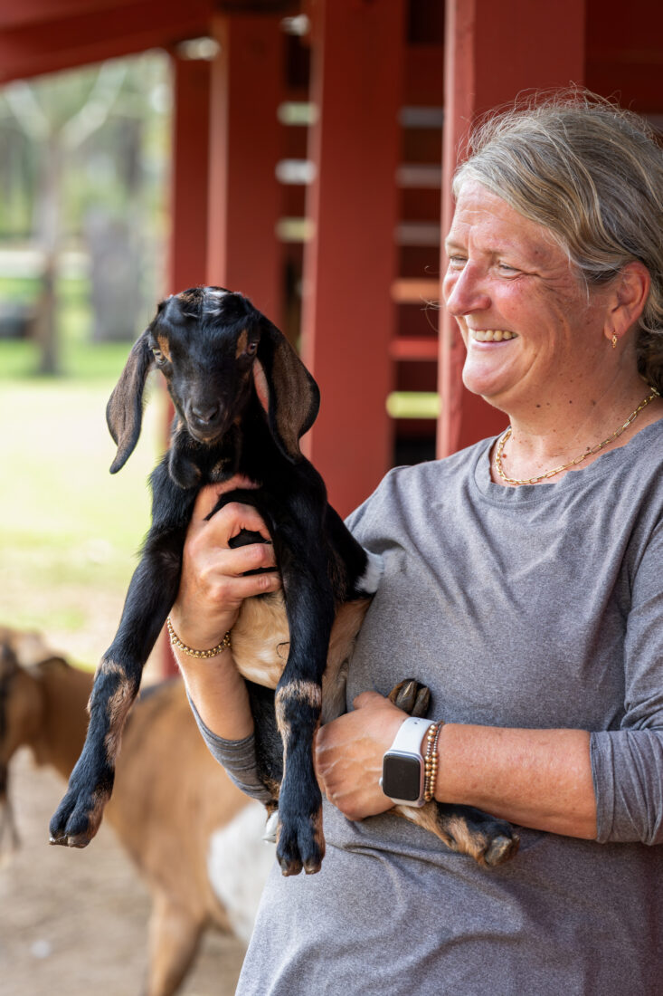 A woman with a baby goat