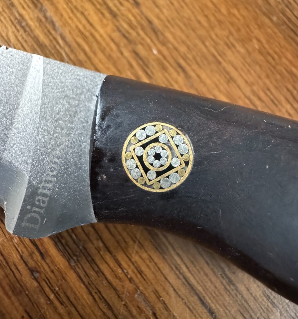 A detail of a pin bolster on a knife