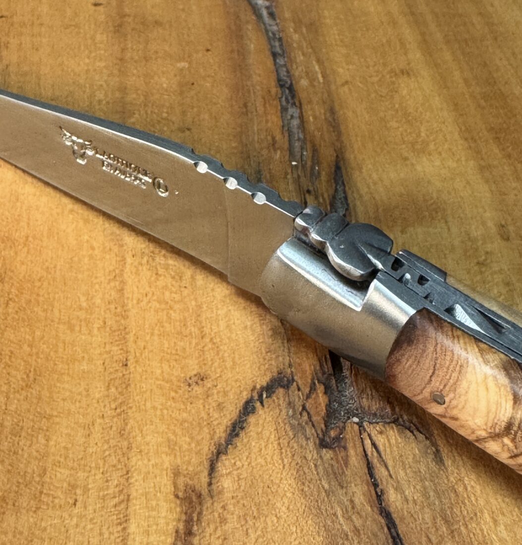 A knife with a carved bee