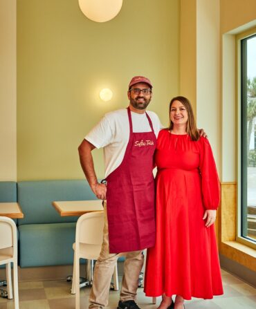 Two people stand in a restaurant