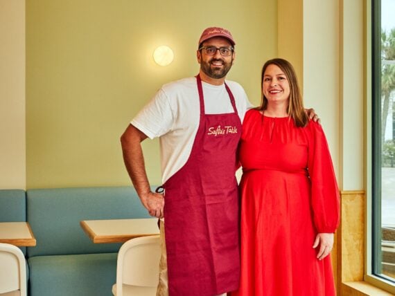 Two people stand in a restaurant