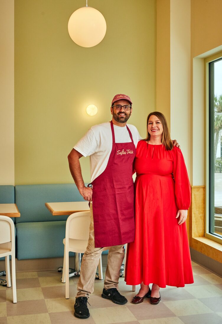 Two people stand in a restaurant