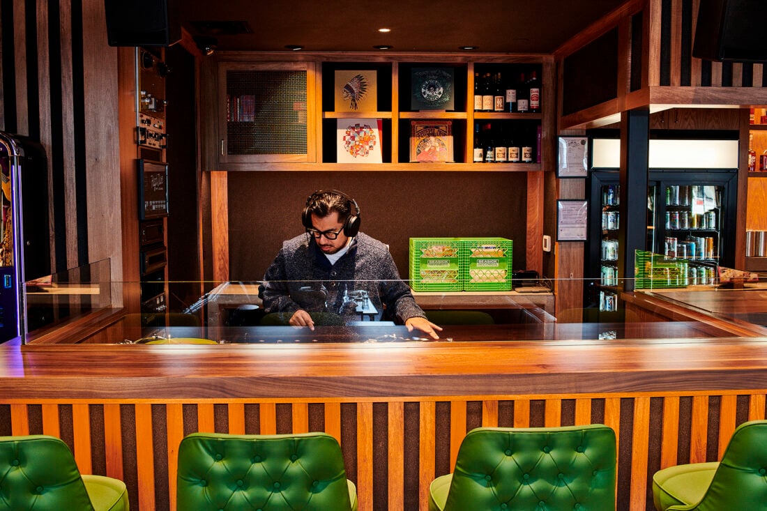 image of a DJ in a wooden booth