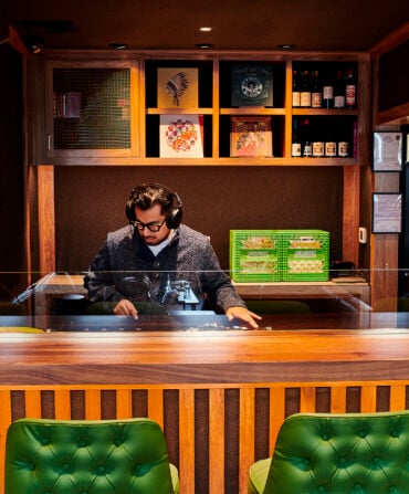 image of a DJ in a wooden booth