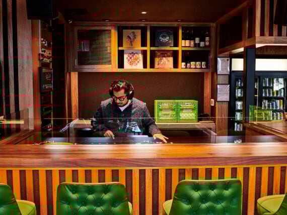 image of a DJ in a wooden booth