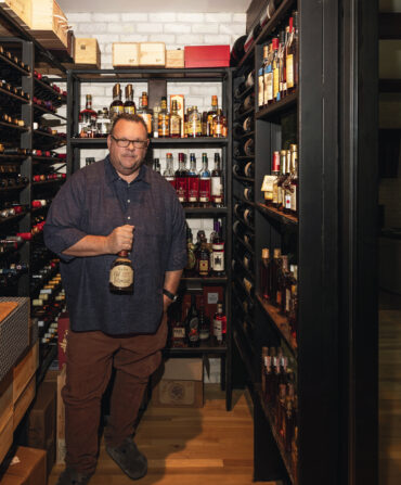 A man in a wine and whiskey room