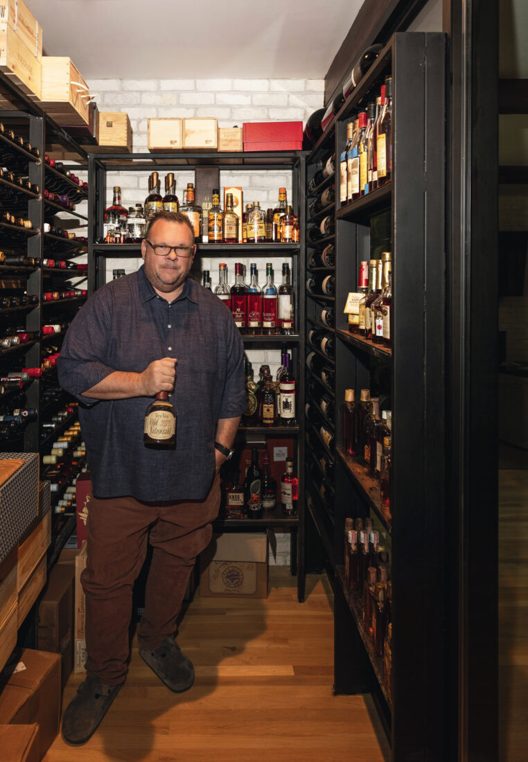 A man in a wine and whiskey room