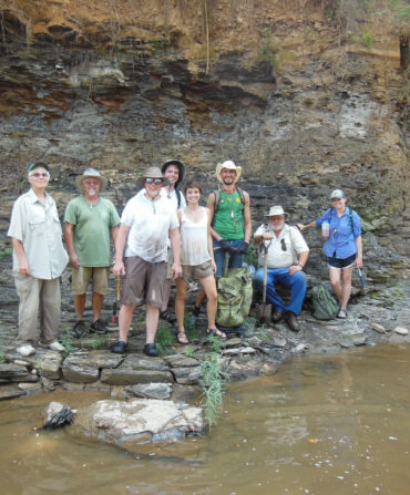 People stand by a creek