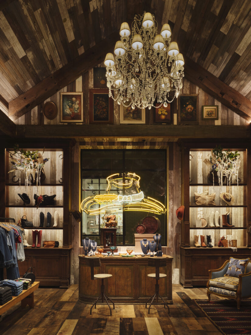 A boutique shop with boots and a neon cowboy hat