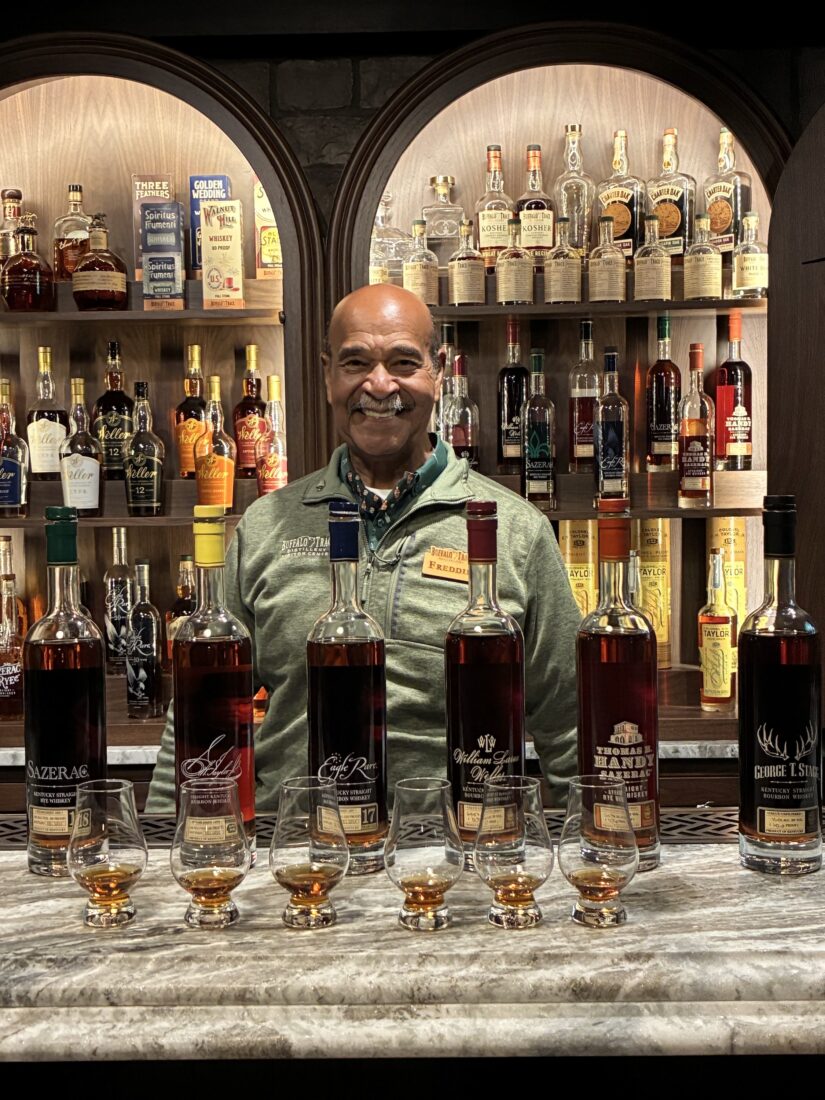 A man behind a bar with bourbon