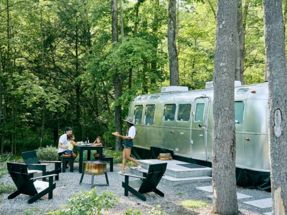 A family camps outside an airstream