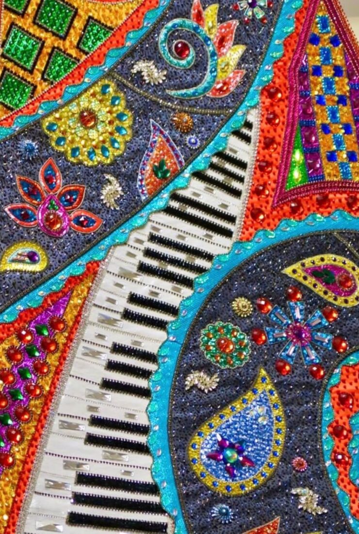 A gown decorated with paisley, decorative swirls and stars, and piano keys