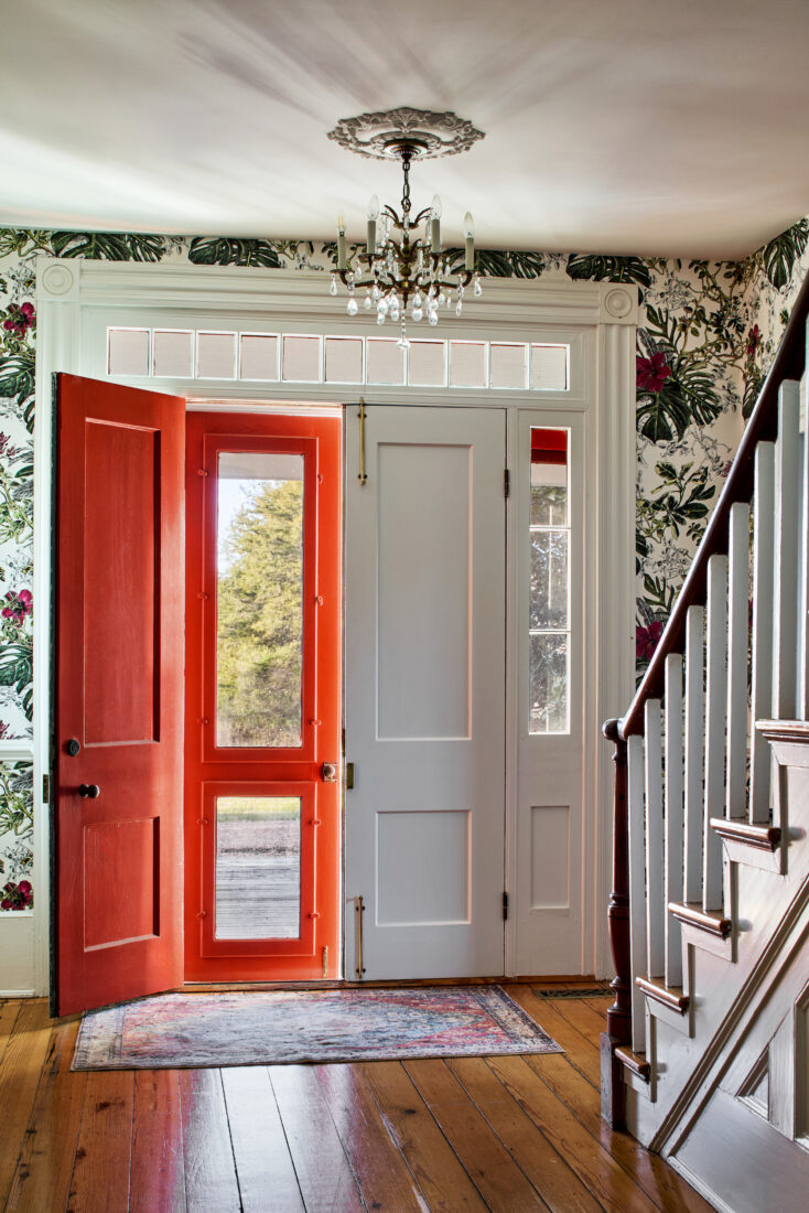 A foyer with a red door
