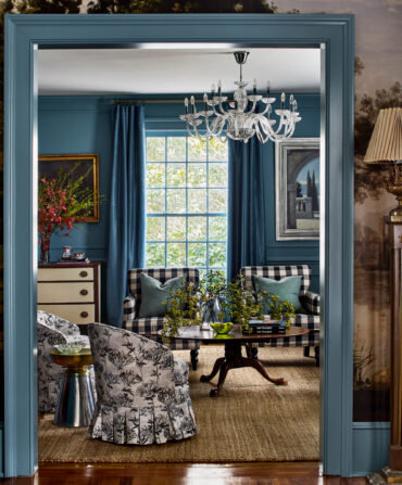 A navy living room with a mural