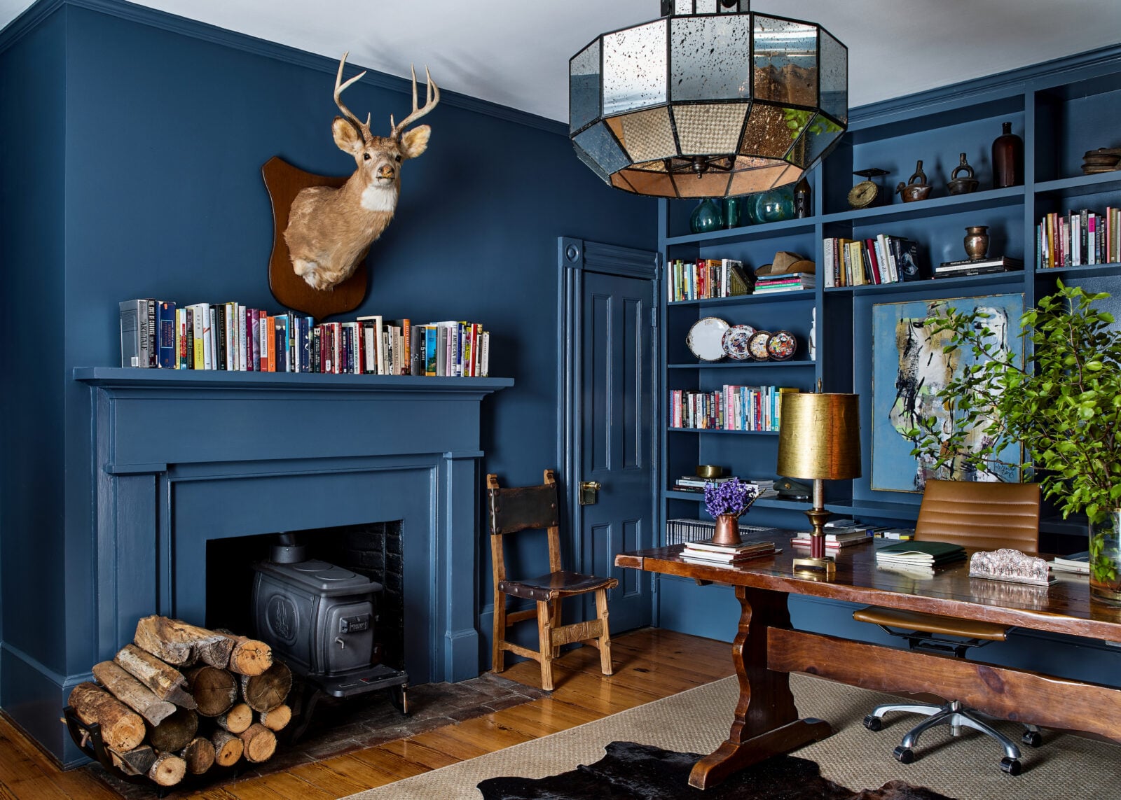 A navy office with books and a deer head