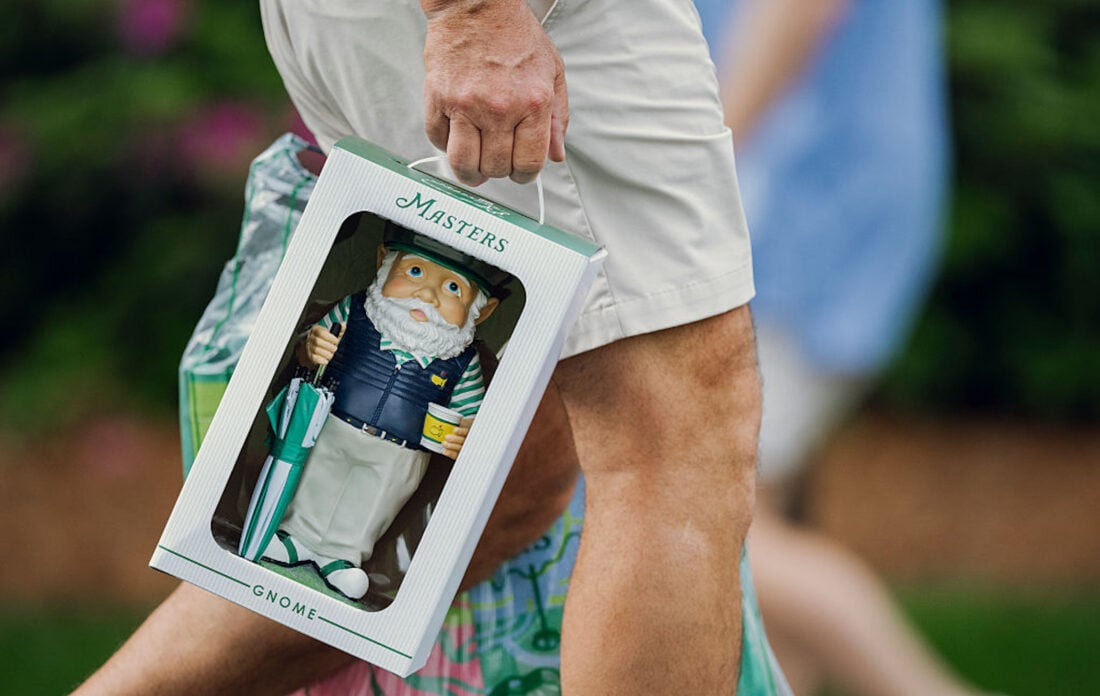 A person carries a garden gnome in a box