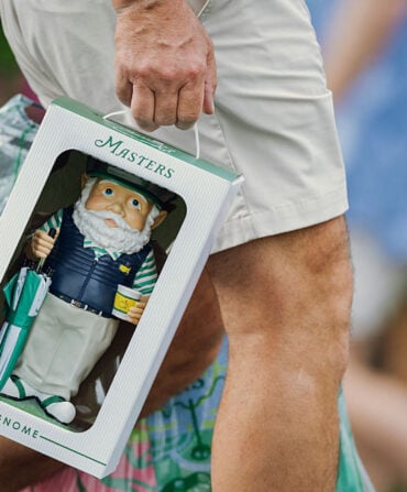 A person carries a garden gnome in a box