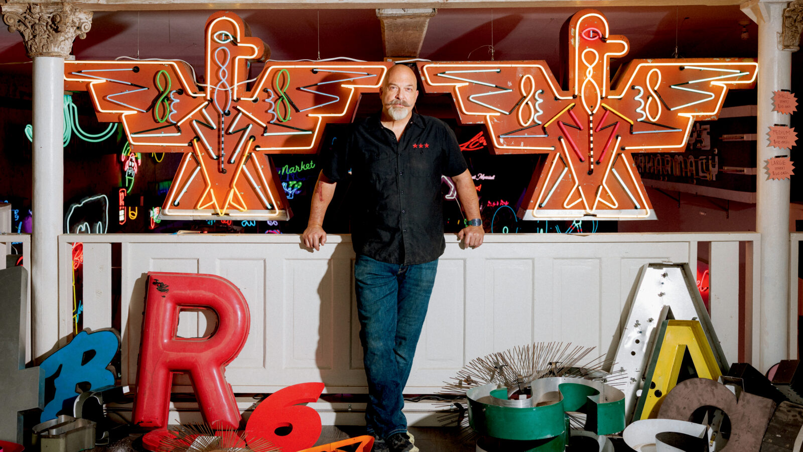 A man in a neon light studio