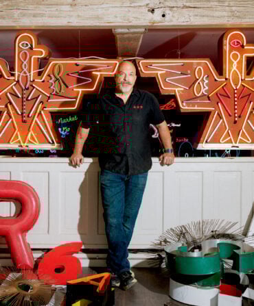 A man in a neon light studio