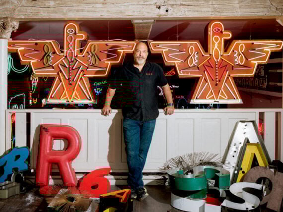 A man in a neon light studio