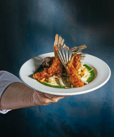 Tempura fish wings, with a Korean glaze and crispy noodle salad on a plate