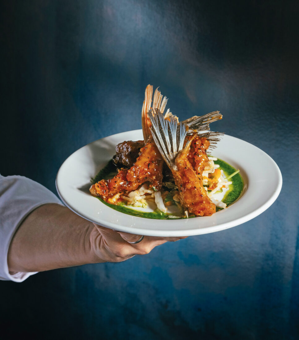Tempura fish wings, with a Korean glaze and crispy noodle salad on a plate