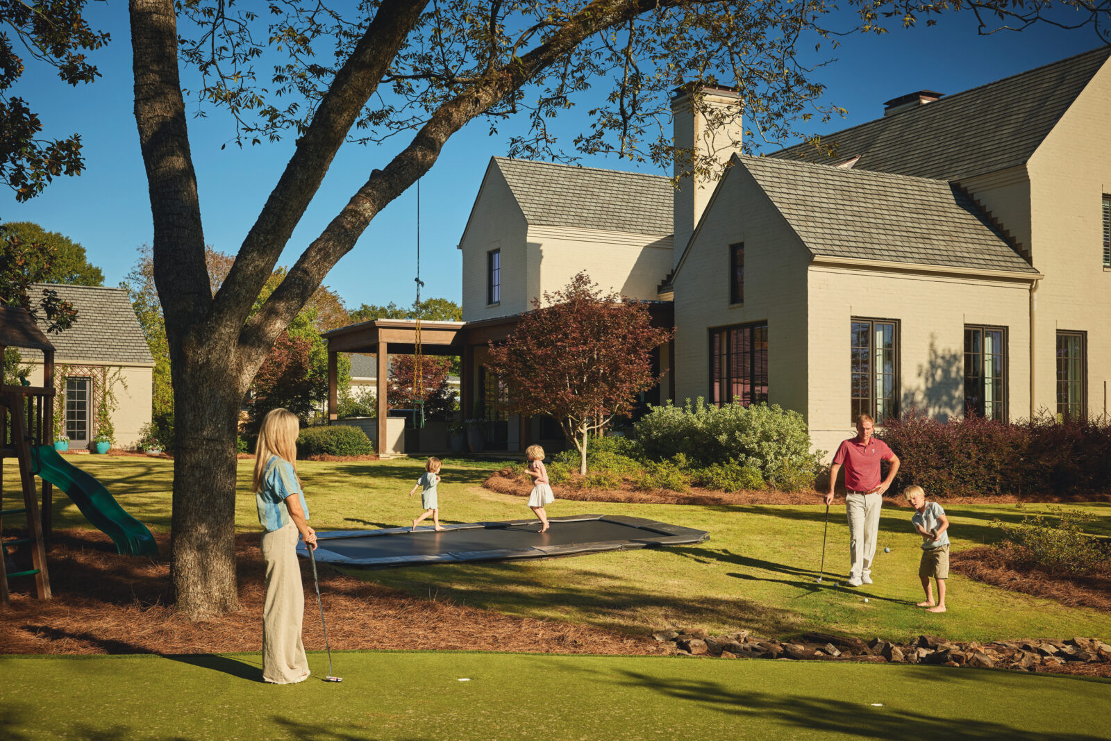 A family plays in a yard