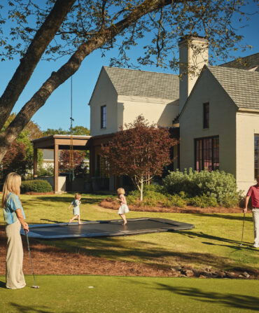 A family plays in a yard