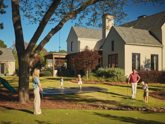 A family plays in a yard