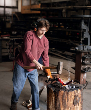 A man forges inside a workshop