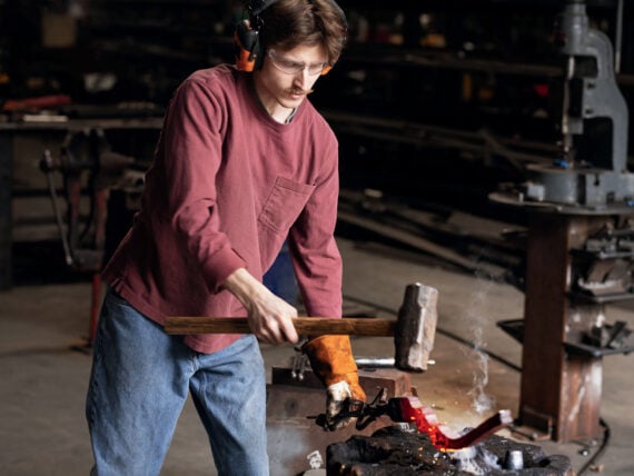 A man forges inside a workshop