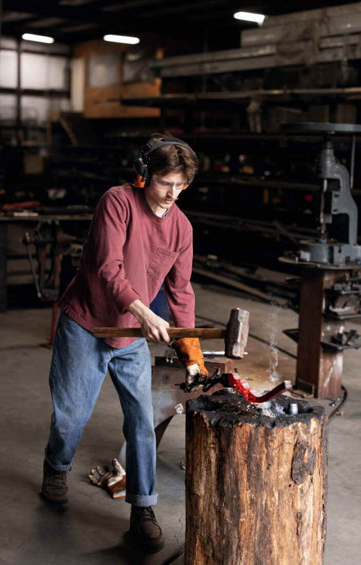 A man forges inside a workshop