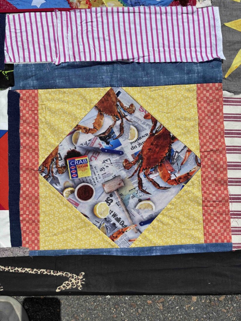 A quilt square depicting a crab boil.