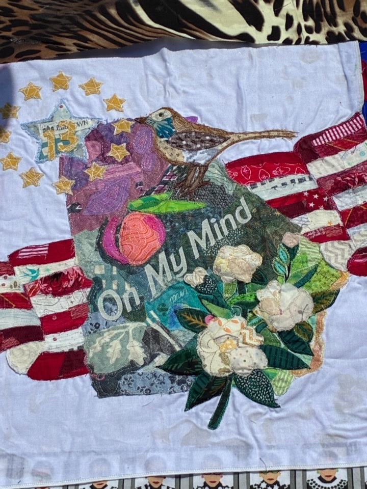 A Georgia quilt square featuring a brown thrasher and sweetbay magnolia flower.