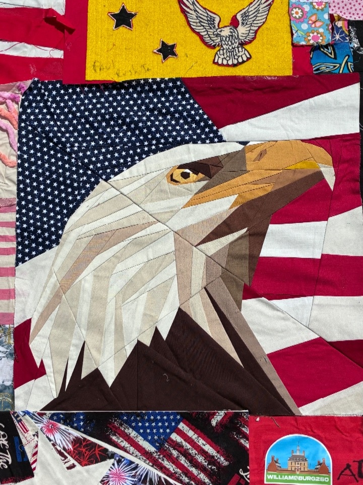 An eagle fashioned from geometric cuts of fabric on a quilt