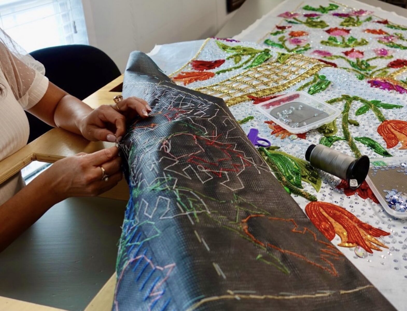 A tulip-themed dress in progress at a table