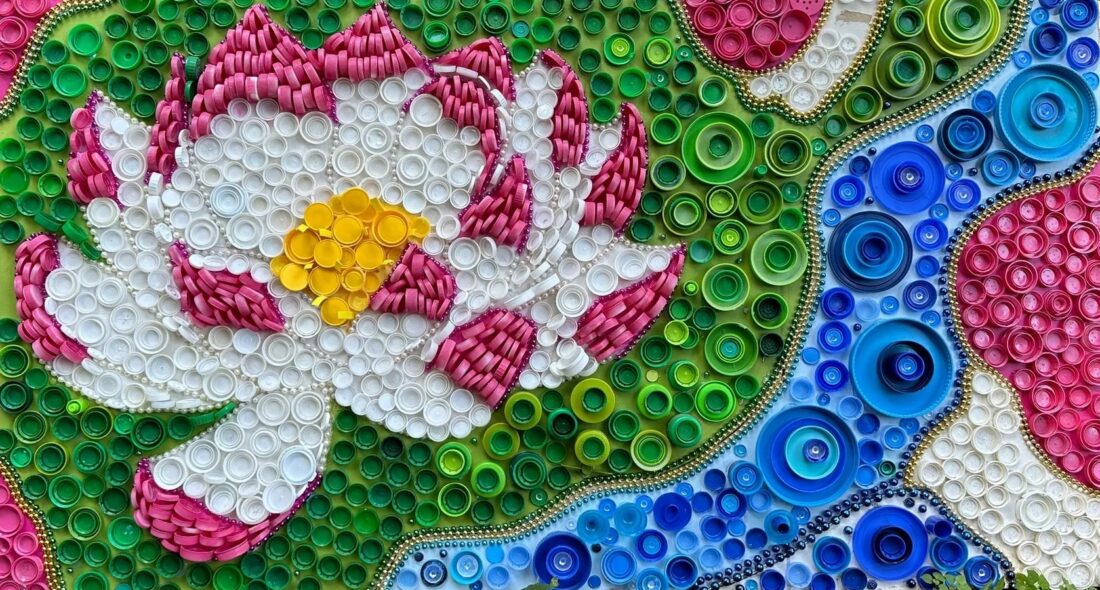 image of a floral bottle-cap artwork made from plastic bottle caps and mardi-gras beads