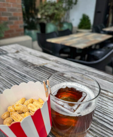 Peanuts and a coke cocktail on a table