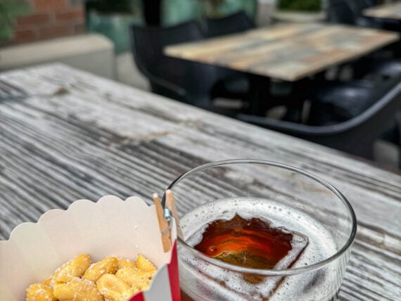 Peanuts and a coke cocktail on a table