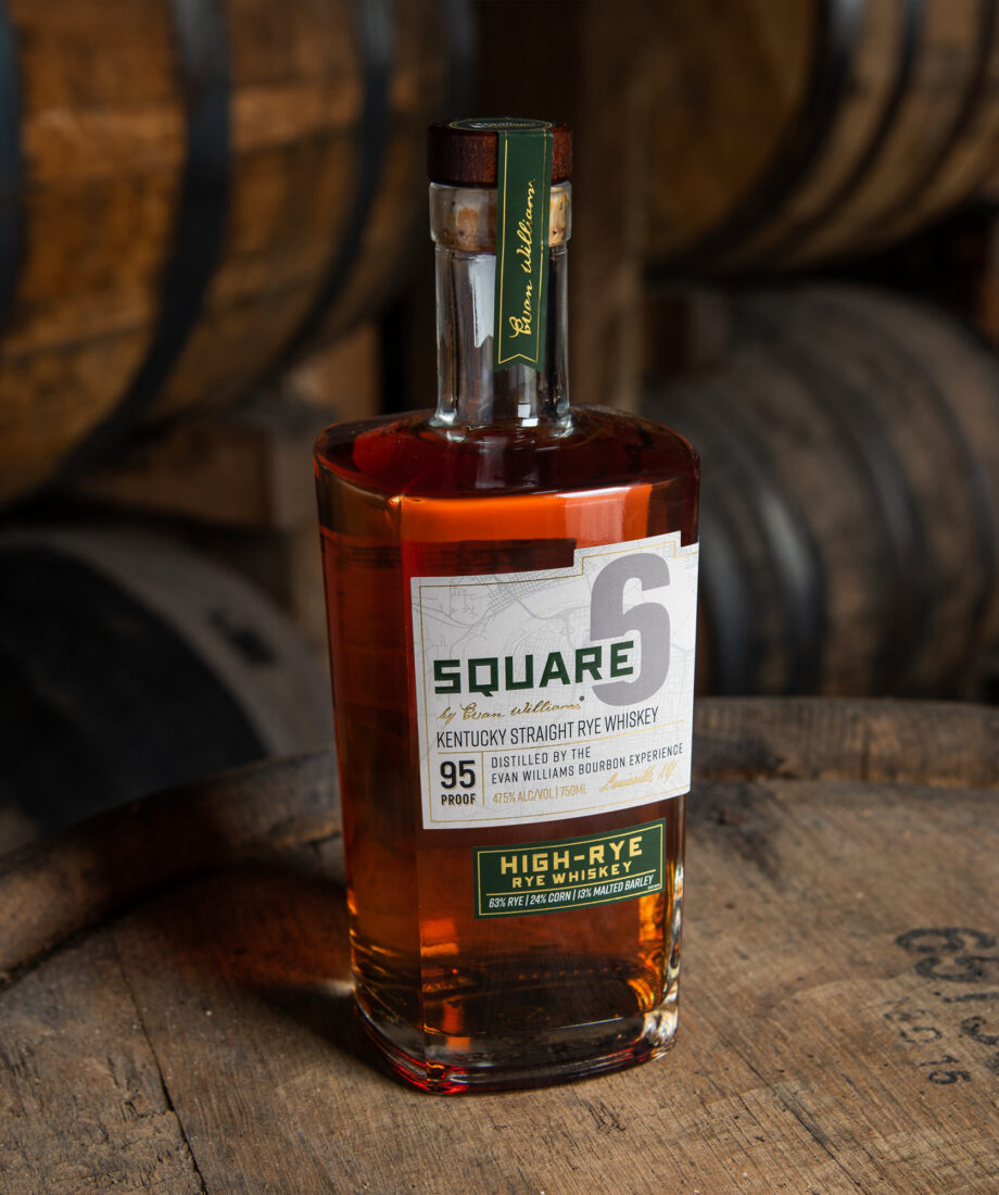 A bourbon bottle on a barrel