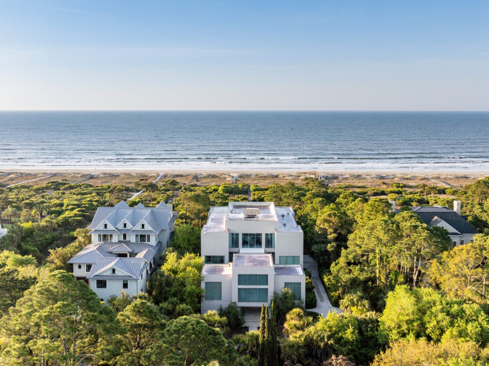 aerial image of the home with the beach in the background